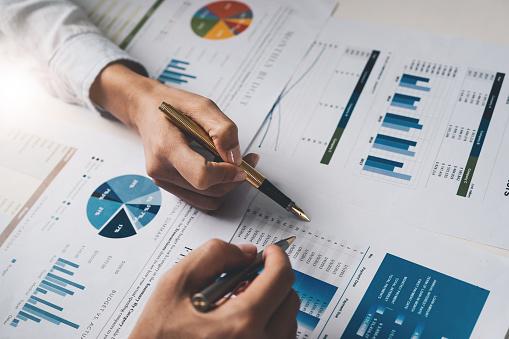 Two business people going over financial reports